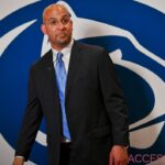 James Franklin standing in front of Penn State logo