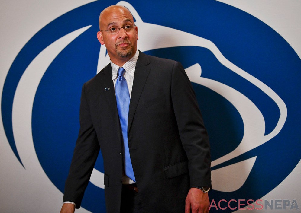 James Franklin standing in front of Penn State logo