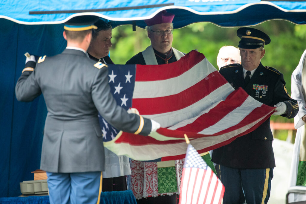Military members folding flag