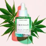 Beauty oil in front of cannabis leaves