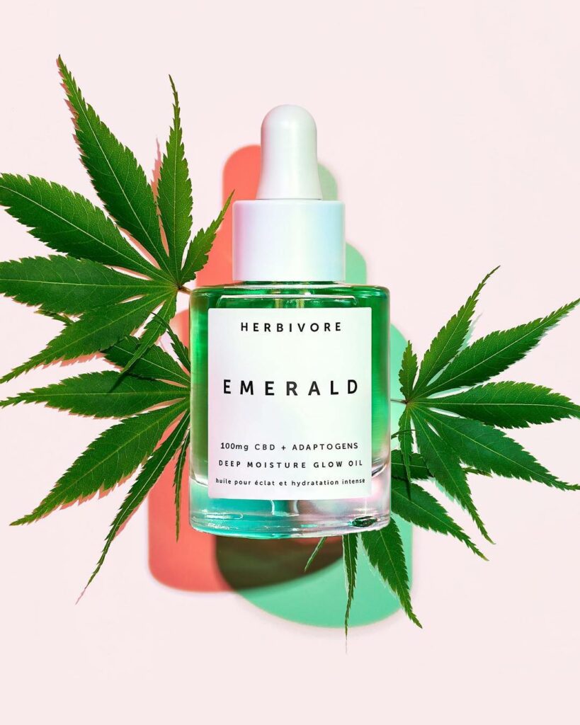Beauty oil in front of cannabis leaves