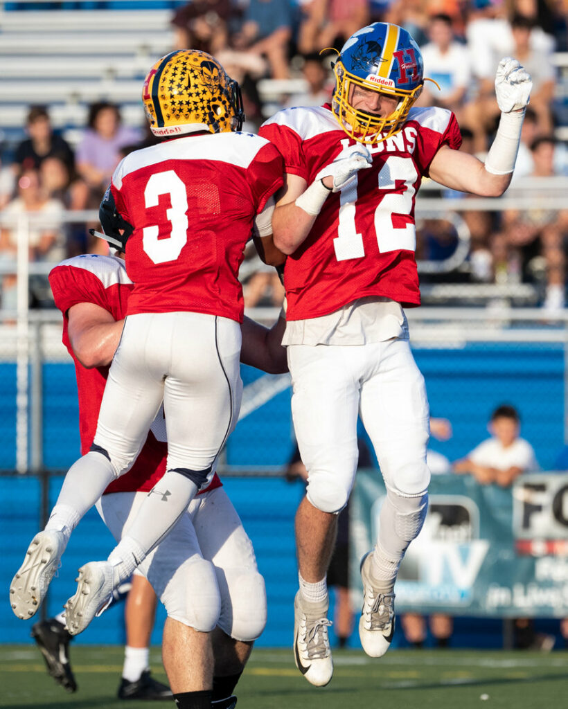 Two players celebrating a touchdown.