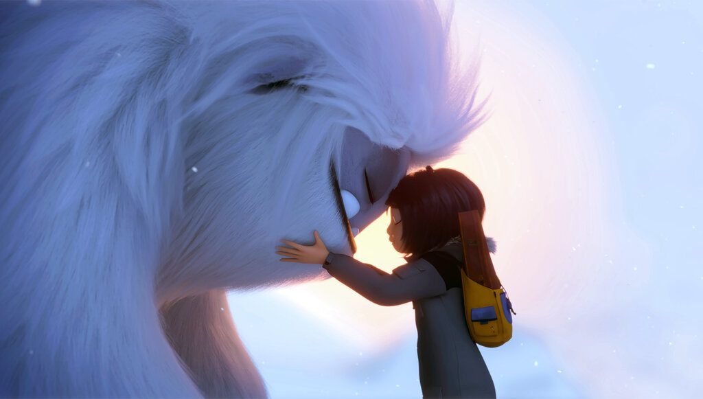 A girl and a Yeti embrace.