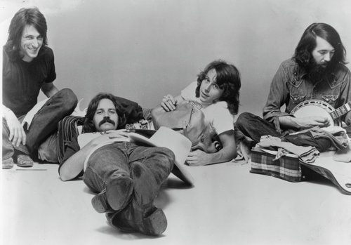 four men sitting on the floor