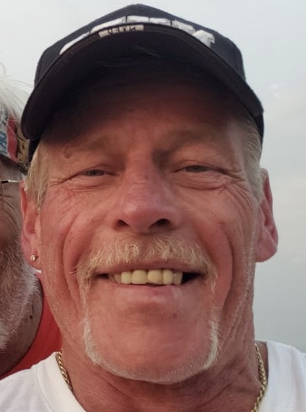 Man in a baseball cap smiles