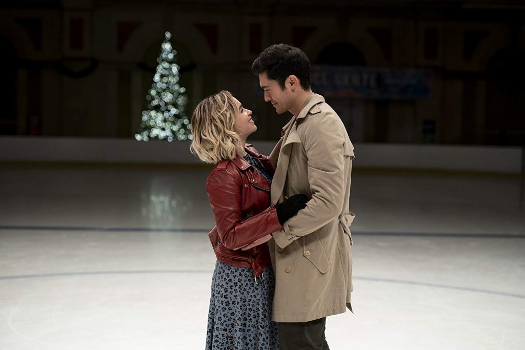 Woman and man ice skate.