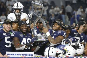 Penn State players hold the Cotton Bowl trophy