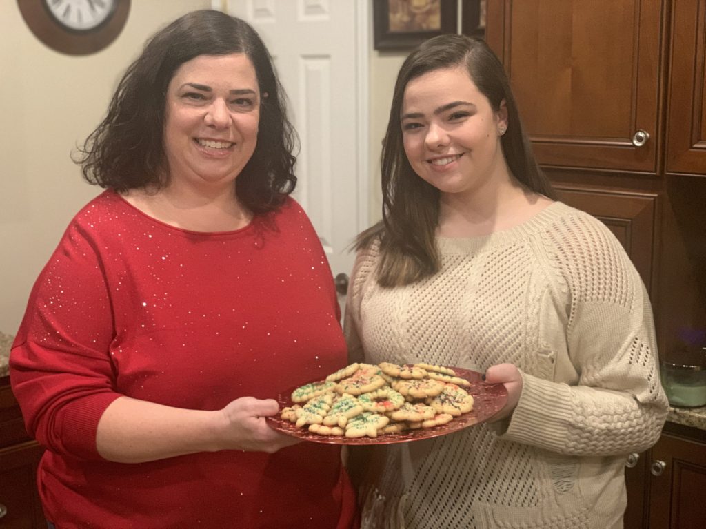GIA MAZUR / STAFF PHOTO Taylor Community Library board president Laurie LaClair, left, with daughter, Julia, earned the library a $50 Riccardo’s Market gift card through Local Flavor Gives Back thanks to her Quick Mix Spritz Cookies recipe.