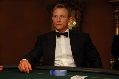 A man in a tuxedo sits at a poker table.