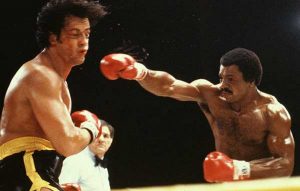 Apollo Creed punching Rocky Balboa